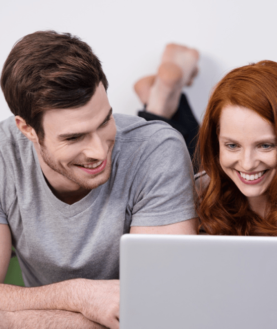 Happy couple with laptop | COLORTILE of Salem